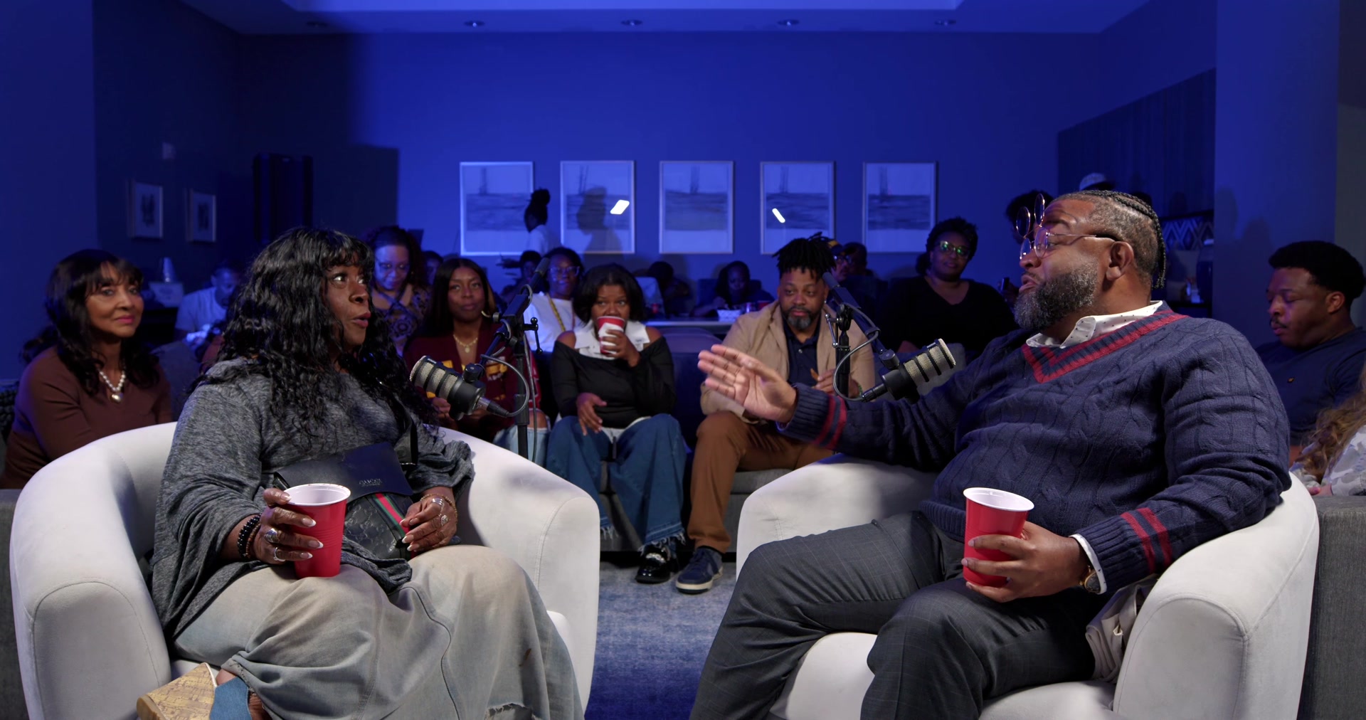 Charnele Brown and Durrell K. Douglas seated together in front of the Live From The Black House audience.